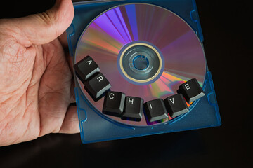 Aufkleber - A hand holding a case with a computer compact disc labeled 