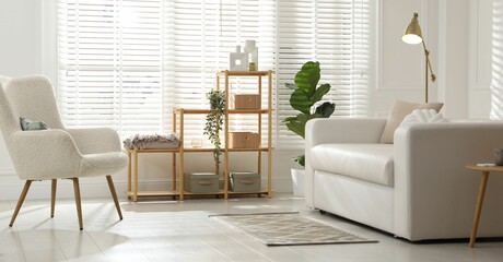 Poster - Stylish shelving unit with decor and sofa in room