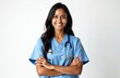 © Pete - Attractive smiling Indian female doctor stands on white background. Woman wears blue scrubs stethoscope. Confident medical worker looks camera. Healthcare, medicine concept.