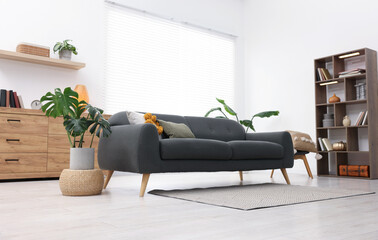 Poster - stylish living room with comfortable sofa and wooden shelving unit. interior design