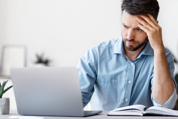 Poster - Concentrated Male Entrepreneur Looking At Laptop Screen While Working On Project In Modern Office, Handsome Businessman Sitting At Desk With Computer, Thinking About Business Solution, Copy Space