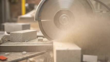 Aufkleber - Dust flies as a circular saw cuts through concrete blocks in a workshop, creating a cloud of particles and demonstrating the power of the tool