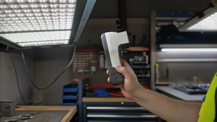 Aufkleber - Workshop technician wearing high visibility vest uses digital lux meter to measure light intensity of led panel, demonstrating proper usage and functionality of device in controlled environment