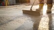 © Mcgui - Cement finisher smoothing freshly poured concrete on a driveway. Featuring skill and attention to detail