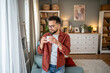 © Migma_Agency - Young man enjoying a cup of coffee in cozy living room