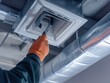 © keshia - HVAC technician adjusting air ducts inside a commercial building. Featuring expertise and precision