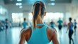 © satisfied - Woman in a Fitness Class, Back View. Determined and Focused on Health and Wellness.