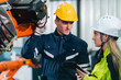 © chokniti - Engineer Technician Working with Robotic Arm in Futuristic Factory: Automation Technology for Efficient Production and Assembly in Manufacturing, Driving Innovation Control in Industrial Plant