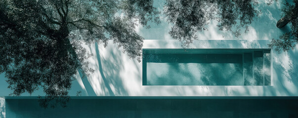 Poster - A tree is casting a shadow on a pool. The pool is surrounded by a white wall. The image has a calm and peaceful mood