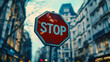 © Yoonnam - A modern, clean red stop sign with bold 'STOP' lettering stands on a city street, symbolizing traffic safety, awareness, control, and the importance of pausing in fast-paced urban life.