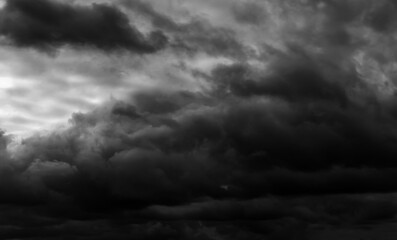 Wall Mural - dark dramatic sky with black stormy clouds before rain as abstract background, extreme weather
