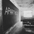© sharafmaksumov - APARTHEID  text related to the type of discrimination written on a blackboard