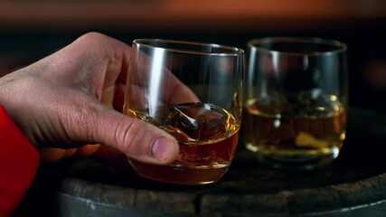 Aufkleber - Super Slow Motion of Man Hand Turning Shot of Whiskey or Rum. Filmed on High Speed Cinema Camera, 1000 fps. Camera in Motion. Low Depth of Focus.