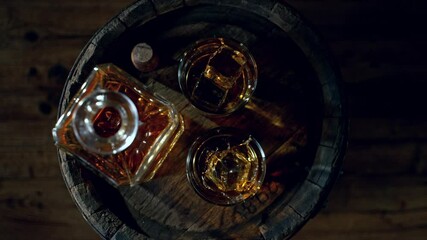 Fototapete - Super Slow Motion of Ice Cube Falling into Glass of Whiskey with Camera Motion. Overhead View. Filmed on High Speed Cinema Camera, 1000 fps.