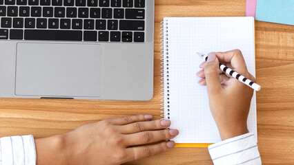 Aufkleber - Workspace. Unrecognizable businesswoman working at laptop and writing in notebook in modern office, top view, copy space
