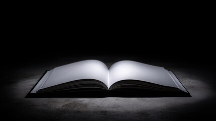 Poster - Open book resting on a table under a warm spotlight creating a reflective atmosphere for ideas and creativity