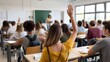 © Zainab - Students in a classroom with one raising hand while the teacher is in front of the chalkboard