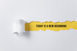 © Paperclip - torn paper background with today is a new beginning message