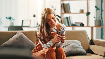 Aufkleber - Phone, relax and woman on sofa in house with networking, communication or contact on mobile app. Happy, cellphone and female person texting on social media for online conversation in living room.