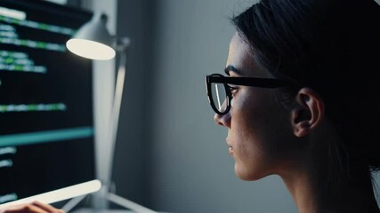 Aufkleber - Female software engineer wearing glasses intently concentrating on computer screen, working late in dimly lit office while developing complex programming solution for innovative technology project