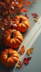 Poster - Autumnal Still Life: Three Pumpkins and Colorful Leaves in Warm Light for Thanksgiving and Fall Decor