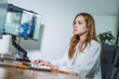 © Hip.hub - Young professional working at a computer desk in a modern office with multiple screens displaying data analytics