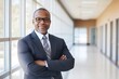 © Dina - diverse school principal standing confidently in a modern school hallway, with a clean, bright background and ample space for text