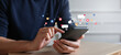 © chinnarach - close up businessman hand use smartphone to work about futuristic of social media and business on online marketing with icon for internet network technology and business concept