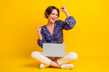 Poster - Full length photo of young crazy winner business woman started her startup successfully using laptop isolated on yellow color background