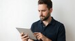 © FAWF STUDIO - Man with tablet in hand and expression of concentration on white background