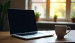 © Supharak wonginyoo - Laptop on desk, empty coffee cup, window view, technology, study