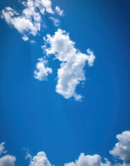Wall Mural - Azure sky, fluffy white clouds, distant twinkling stars, sky, dusk, bright