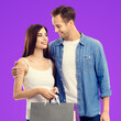 © vgstudio - Image - happy smile young couple, boyfriend and girlfriend. Man in blue denim shirt, woman hold carry shop bags packages wear white tank top isolated purple background. Holiday sale ad concept. Square