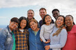 © Sabrina - Group of multiracial friends smiling on camera outdoor - Multi generational people hugging each other - Community, social inclusion and lifestyle concept