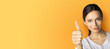 © vgstudio - Image - smiling business woman show thumb up hand sign. Black hair cute businesswoman, in white cloth point positive success gesture, isolated orange yellow background. Banner ad text free space