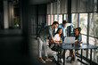© NDABCREATIVITY - Mixed team of software engineers brainstorming ideas. Diverse app developers collaborating as group