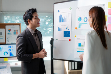 Poster - Business partners discussing company strategy and analyzing financial charts on whiteboard