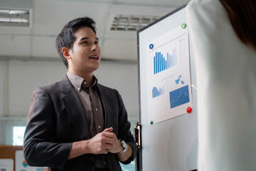 Poster - Young professional explaining company strategy during a business meeting using charts and graphs