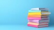 © khonkangrua - Colorful Stacked Books on Blue Background for Education, Learning, Study, or Reading Concepts