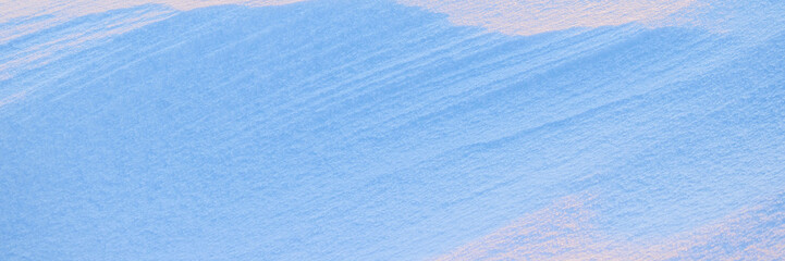 Wall Mural - beautiful winter background with snowy ground. natural snow texture. wind sculpted patterns on snow 