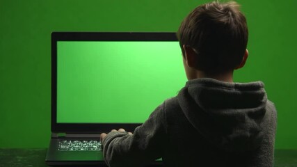 Poster - Young Boy Observes Laptop With Green Screen for Creative Projects Generative AI