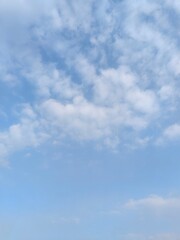 Wall Mural - cloudy blue sky. a blue sky filled with fluffy clouds, natural lighting, high - quality