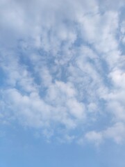Wall Mural - cloudy blue sky. a blue sky filled with fluffy clouds, natural lighting, high - quality
