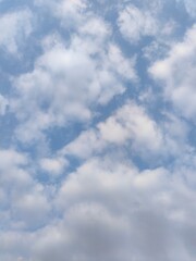 Wall Mural - cloudy blue sky. a blue sky filled with fluffy clouds, natural lighting, high - quality