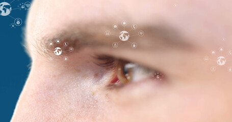 Poster - image of icons over eye of caucasian man on blue background
