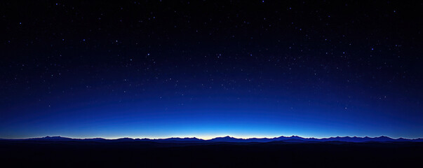 A dark sky with a few stars and a horizon. The sky is blue and the stars are scattered throughout
