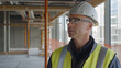 © Velem - Construction manager inspecting the worksite progress. Featuring project oversight and coordination