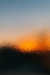 Wall Mural - Beautiful Sunset Reflected Through Frosted Glass Surface