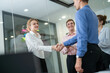 © Hip.hub - Professional meeting in modern office with team members collaborating and shaking hands after a discussion