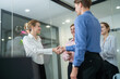 © Hip.hub - Business professionals engage in a handshake during a collaborative meeting in a modern office space
